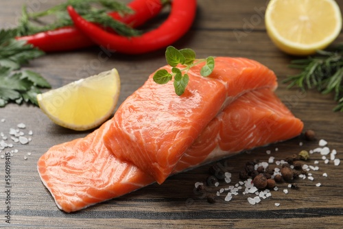 Fresh salmon and ingredients for marinade on wooden table