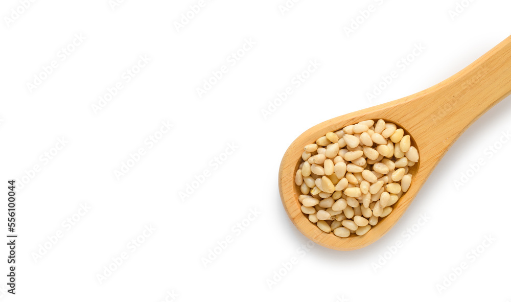 Wooden spoon with pine nuts on a white background. Top view, copy space. Healthy food concept Wooden spoon with pine nuts on a white background. Top view, copy space. Healthy food concept