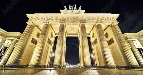 The Brandenburg Gate time lapse footage at evening time, tourists walking around, camera movement from bottom to top, wide angle. Berlin Germany photo