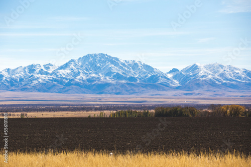 Plowed field and snow-capped mountains, Autumn Kazakhstan landscape