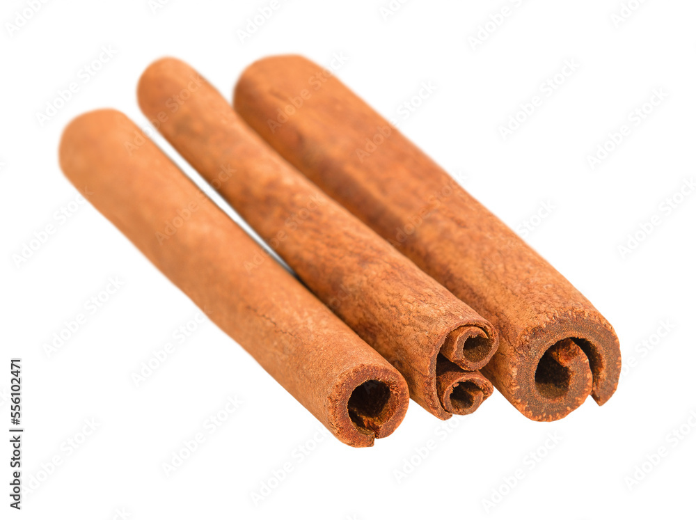 cinnamon sticks in a row lie on a white background cinnamon sticks in a row lie on a white background
