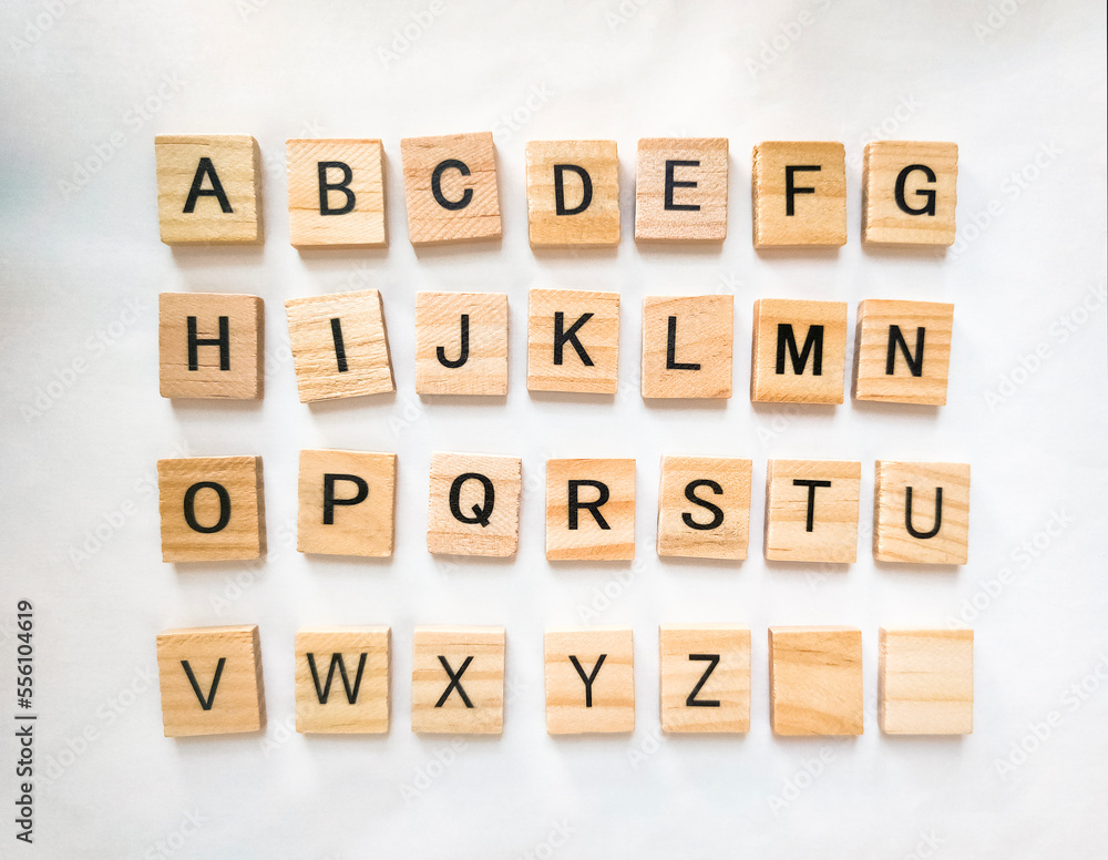 Letters of the alphabet on wooden parts on white background Letters of the alphabet on wooden parts on white background