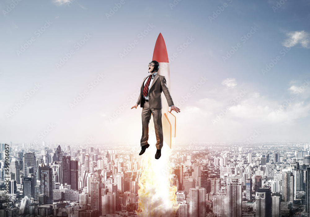 Business person in aviator hat flying on rocket