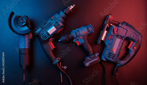 Set of new power tools isolated on a black background, drill, puncher, electric saw, jigsaw, circular saw