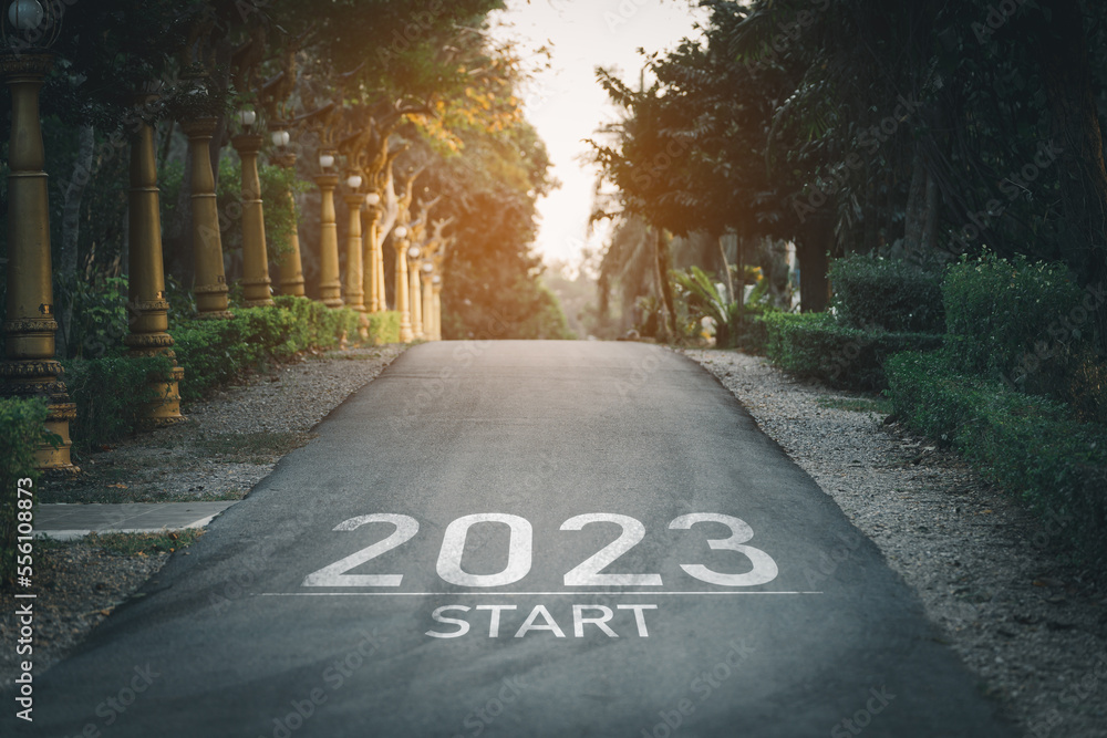 Happy new year 2023,2023 symbolizes the start of the new year. The letter start new year 2023 on the road in the nature garden park have tree environment ecology or greenery wallpaper concept. - obrazy, fototapety, plakaty 