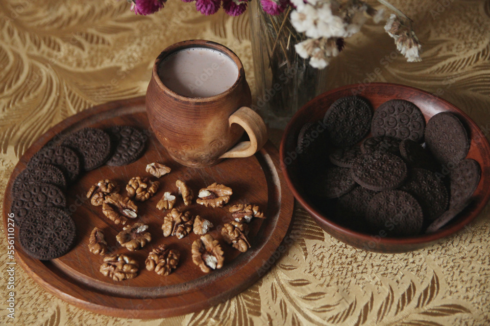 Still life of delicious sweet cookies with milk, flowers and nuts. Still life of delicious sweet cookies with milk, flowers and nuts.