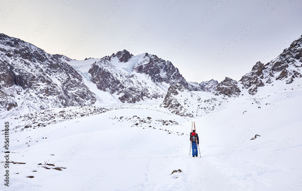 Skier climb at high snowy mountains