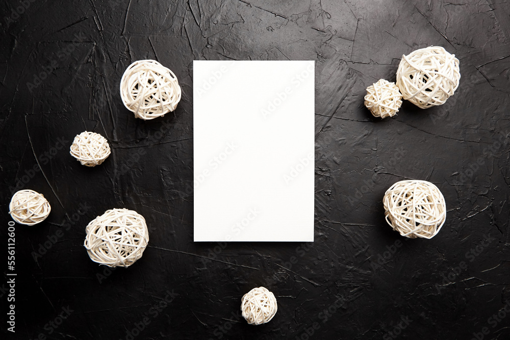 Card mockup, blank wedding invitation with white white balls decor on black table Card mockup, blank wedding invitation with white white balls decor on black table