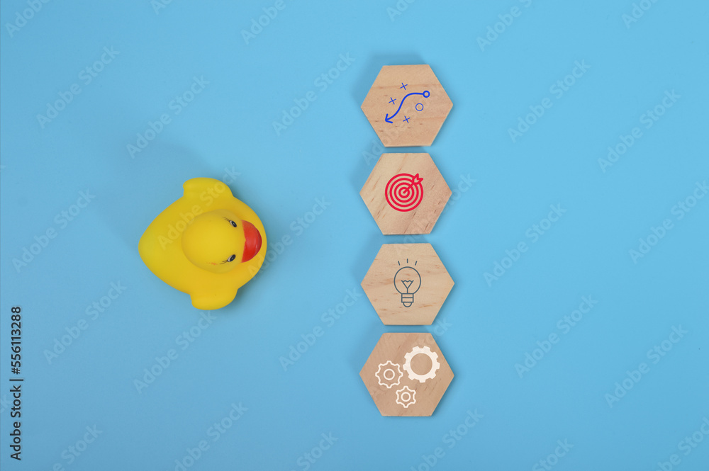 Toy duck and wooden blocks with strategy, success, new idea and innovation symbols. Toy duck and wooden blocks with strategy, success, new idea and innovation symbols.