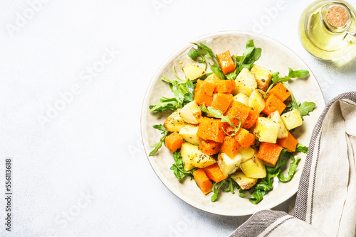Warm salad with pumpkin, potato and arugula.
