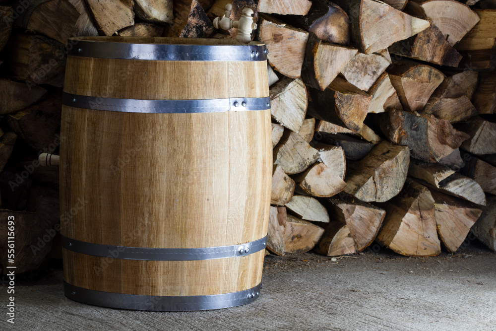 oak barrel on the background of firewood oak barrel on the background of firewood