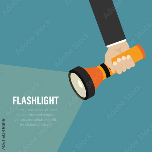 Flashlight in businessman hand and beam of light. Place for advertising and text. Handheld electric flashlight illuminates part of the room.