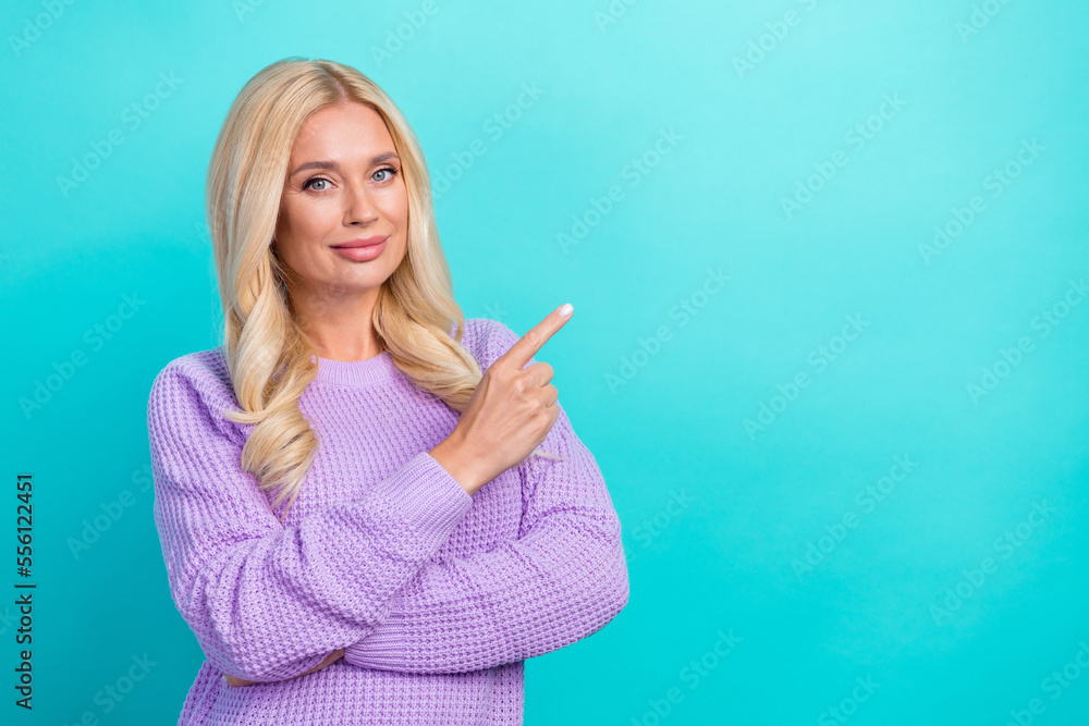 Photo of middle aged serious charming business lady pointing finger empty space new company details info isolated on aquamarine color background Photo of middle aged serious charming business lady pointing finger empty space new company details info isolated on aquamarine color background