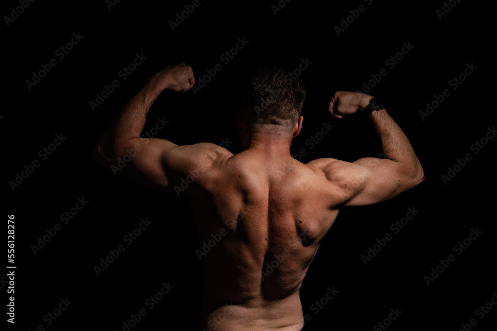 Sexy portrait of muscular handsome topless male isolated against a grey background Sexy portrait of muscular handsome topless male isolated against a grey background