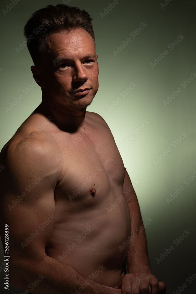 Sexy portrait of muscular handsome topless male isolated against a coloured background Sexy portrait of muscular handsome topless male isolated against a coloured background