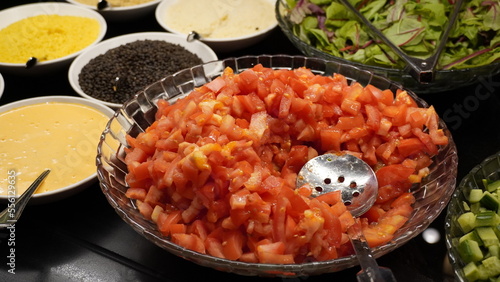 A salad of chopped  tomatoes in a bowl