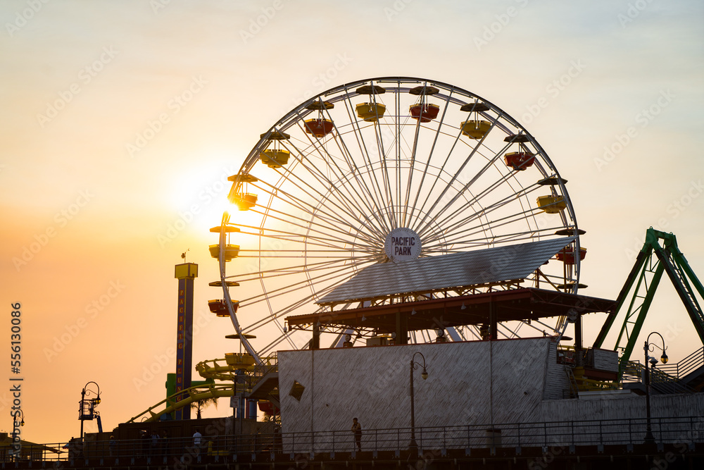 ferris wheel of santa monica pier theme park at sunset