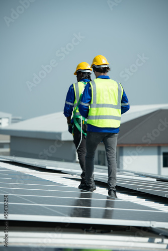 Both of Engineer in charge of solar panel installation The installation of solar energy conversion into electricity for a warehouse is currently being investigated.