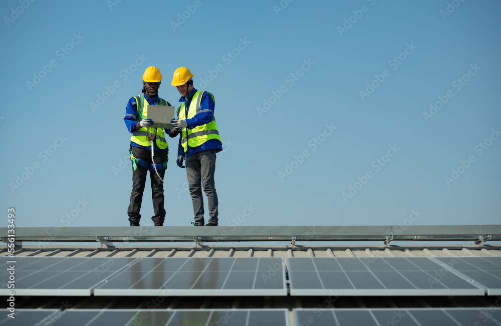 Both of Engineer in charge of solar panel installation The installation of solar energy conversion into electricity for a warehouse is currently being investigated.