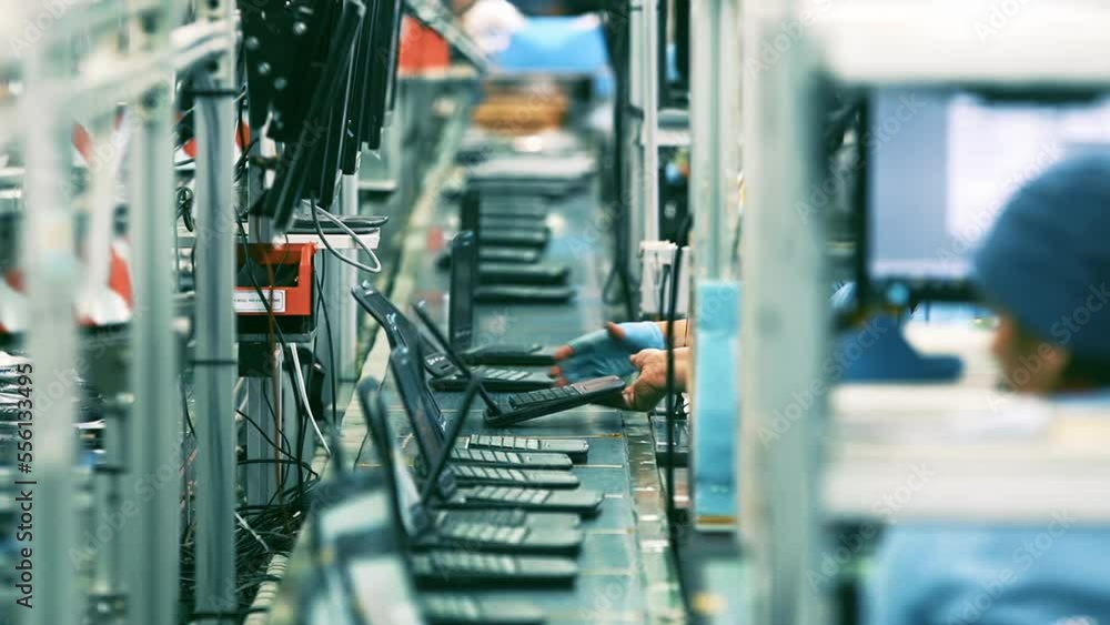 Fabrication of Laptop Computers, Assembly Line Workers Producing Notebooks. 4K Resolution. Fabrication of Laptop Computers, Assembly Line Workers Producing Notebooks. 4K Resolution.