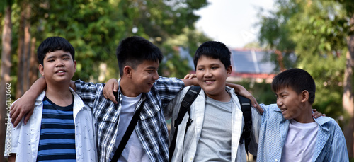 Young asian boys smilling, hugging and laughing together between taking weekend after midterm test, soft and selective focus, crop shot.