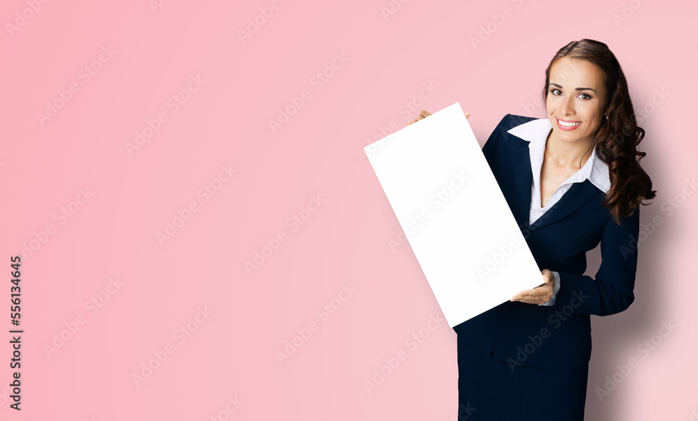 Happy smiling woman in black confident suit showing blank white signboard. Business and advertising concept. Copy space empty place for text. Pink color background.. Happy smiling woman in black confident suit showing blank white signboard. Business and advertising concept. Copy space empty place for text. Pink color background..