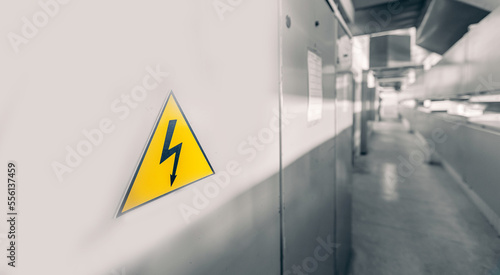 Switchboard equipment of power plant. Lightning sign on yellow background