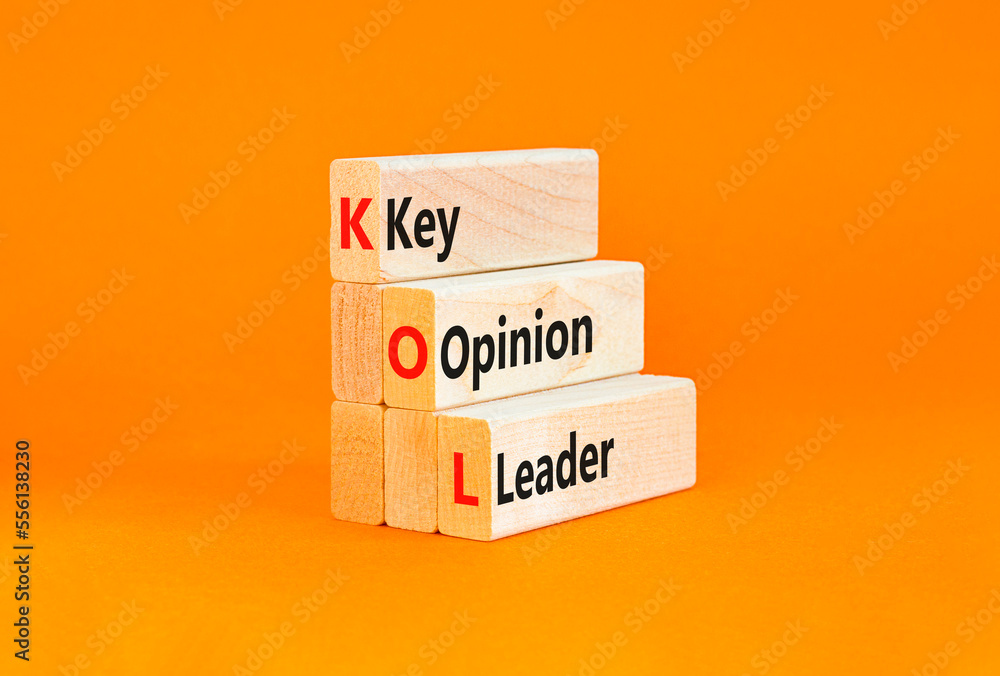 Naklejka premium KOL key opinion leader symbol. Concept words KOL key opinion leader on wooden blocks on a beautiful orange table orange background. Business KOL key opinion leader concept. Copy space.