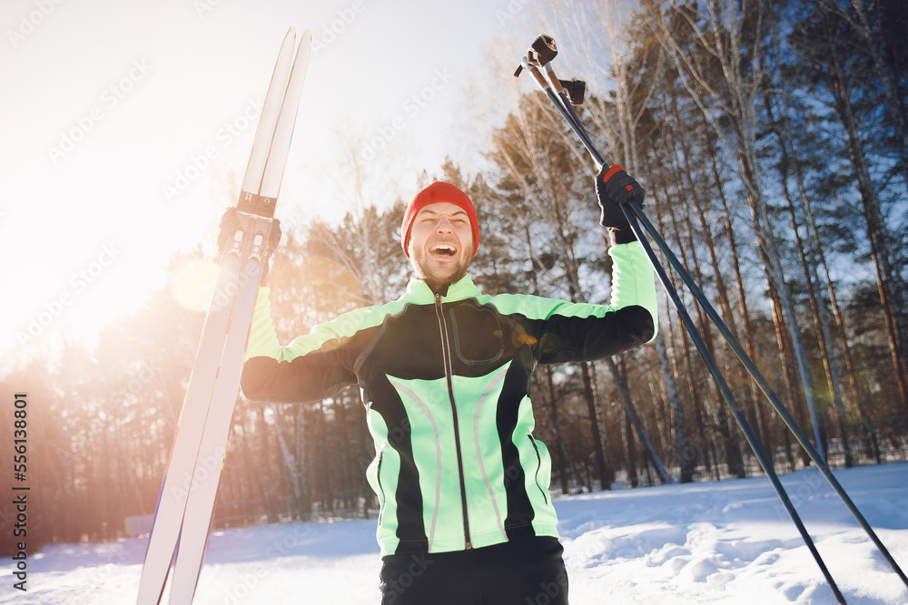 Portrait sportsman happy man with cross country skiing background winter forest, sunny day