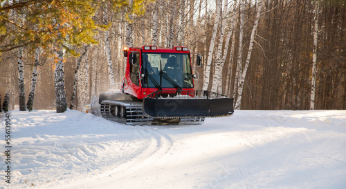 Process prepares way for cross-country ski with red modern machine ratrack preparing ski slope