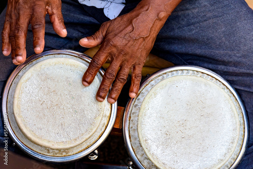 Hands and istrument of musician playing bongo in the streets of Pelourinho in Salvador in Bahia photo