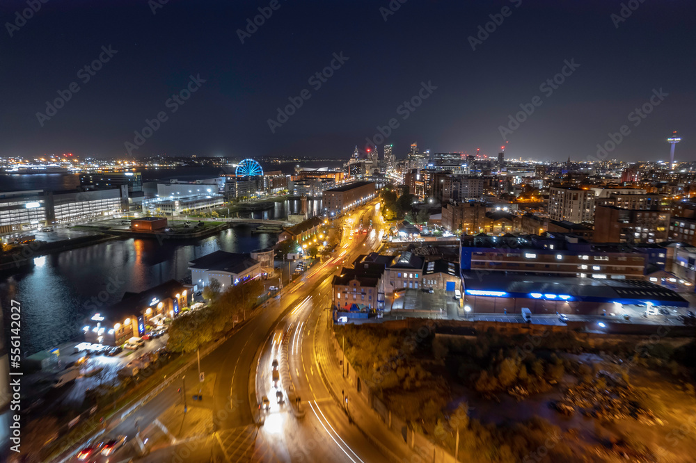 Aerial River Mersey and Liverpool skyline at night with light streaks from traffic