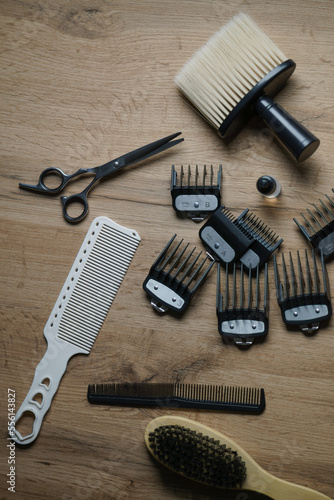 Barbershop tools on a wooden table, hair cutting tools on a wooden table, barbershop equipment on a wooden table, view from above, top view