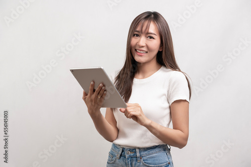 Young asian woman using tablet over white background, technology concept