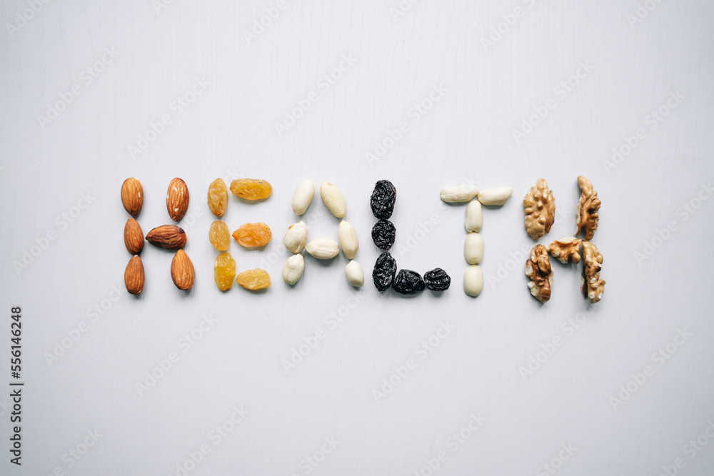The word Health is lined with nuts and dried fruits. Healthy lifestyle, sports. The word Health is lined with nuts and dried fruits. Healthy lifestyle, sports.