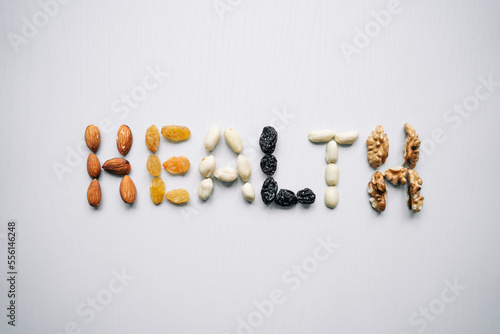 The word Health is lined with nuts and dried fruits. Healthy lifestyle, sports.