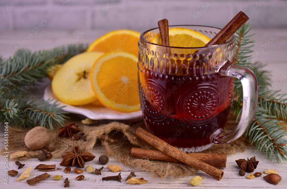 Christmas mulled wine with spices and fruits in a cup. Traditional hot drink for Christmas
Christmas mulled wine with spices and fruits in a cup. Traditional hot drink for Christmas