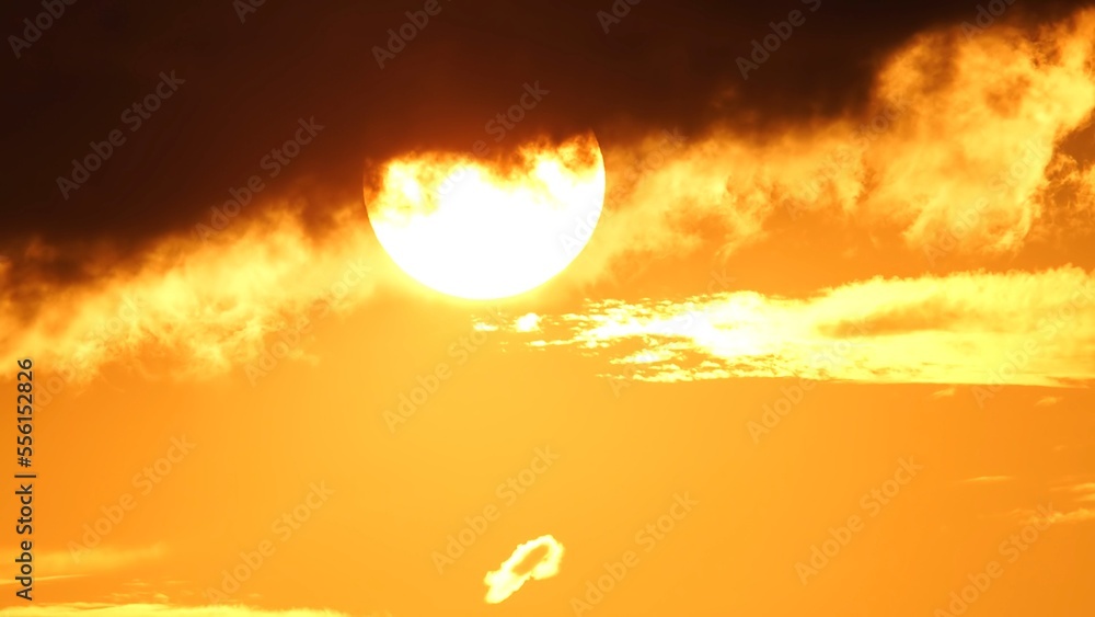 Epic sunset in the sky at hot summer. Cinematic white yellow orange sun movement. Dramatic sun set shot with telephoto lens. Epic sunset in the sky at hot summer. Cinematic white yellow orange sun movement. Dramatic sun set shot with telephoto lens.