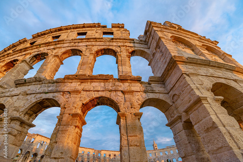 Pula Amphitheater at sunset, also known as Coliseum of Pula, is a well-preserved Roman amphitheater in Pula, Istria, Croatia. ancient arena was built in 27 BC -68 AD by Roman Empire