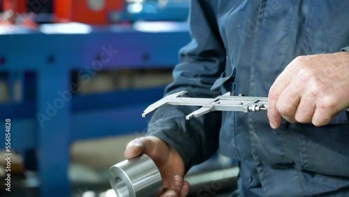 Close Up Of Worker Makes A Control Measurement of the part with a vernier caliper