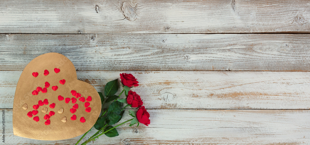 Large gold heart with rose flowers and small red hearts on top of white rustic wood for a happy Valentines day setting Large gold heart with rose flowers and small red hearts on top of white rustic wood for a happy Valentines day setting