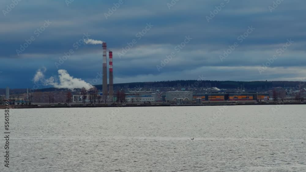 View of the tall chimneys of an industrial enterprise with a chimney polluting the atmosphere. The plant for the production of strategic intercontinental missiles View of the tall chimneys of an industrial enterprise with a chimney polluting the atmosphere. The plant for the production of strategic intercontinental missiles