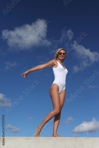 young beautiful woman in a white swimsuit