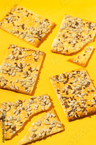 Crunchy cereal cookies closeup on bright orange background. Healthy dessert concept.