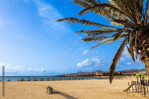 Sunny summer day on the city beach in the resort popular town of Caleta de Fuste, Fuerteventura, Canary Islands Spain