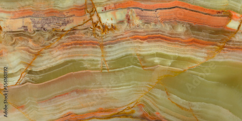Onyx texture. Green and orange streaks on semi-precious stone surface, variety of agate