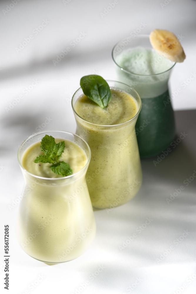 Freshly blended fruit smoothies of various colors and tastes in glass jars. Yellow green. Freshly blended fruit smoothies of various colors and tastes in glass jars. Yellow green.