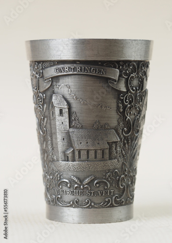 Traditional German vintage pewter wine glass with a bas-relief depicting the evangelical church of Saint Veit in the town of Gartringen photo