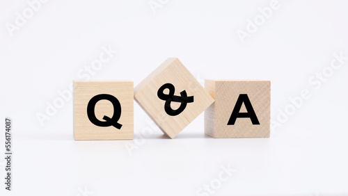 Foto QA - acronym from wooden blocks with letters, questions and answers concept, top