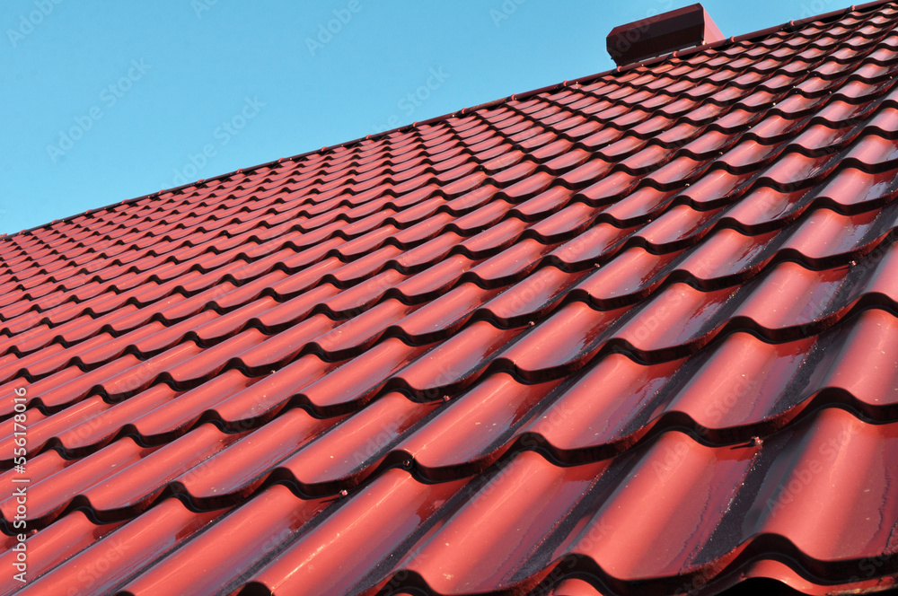 The roof of the house is covered with metal tiles The roof of the house is covered with metal tiles